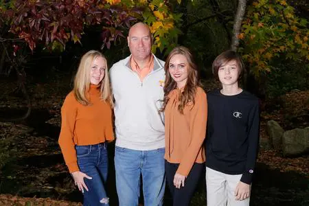 Family portrait with fall foliage background.