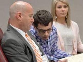 A man and woman seated in a courtroom.